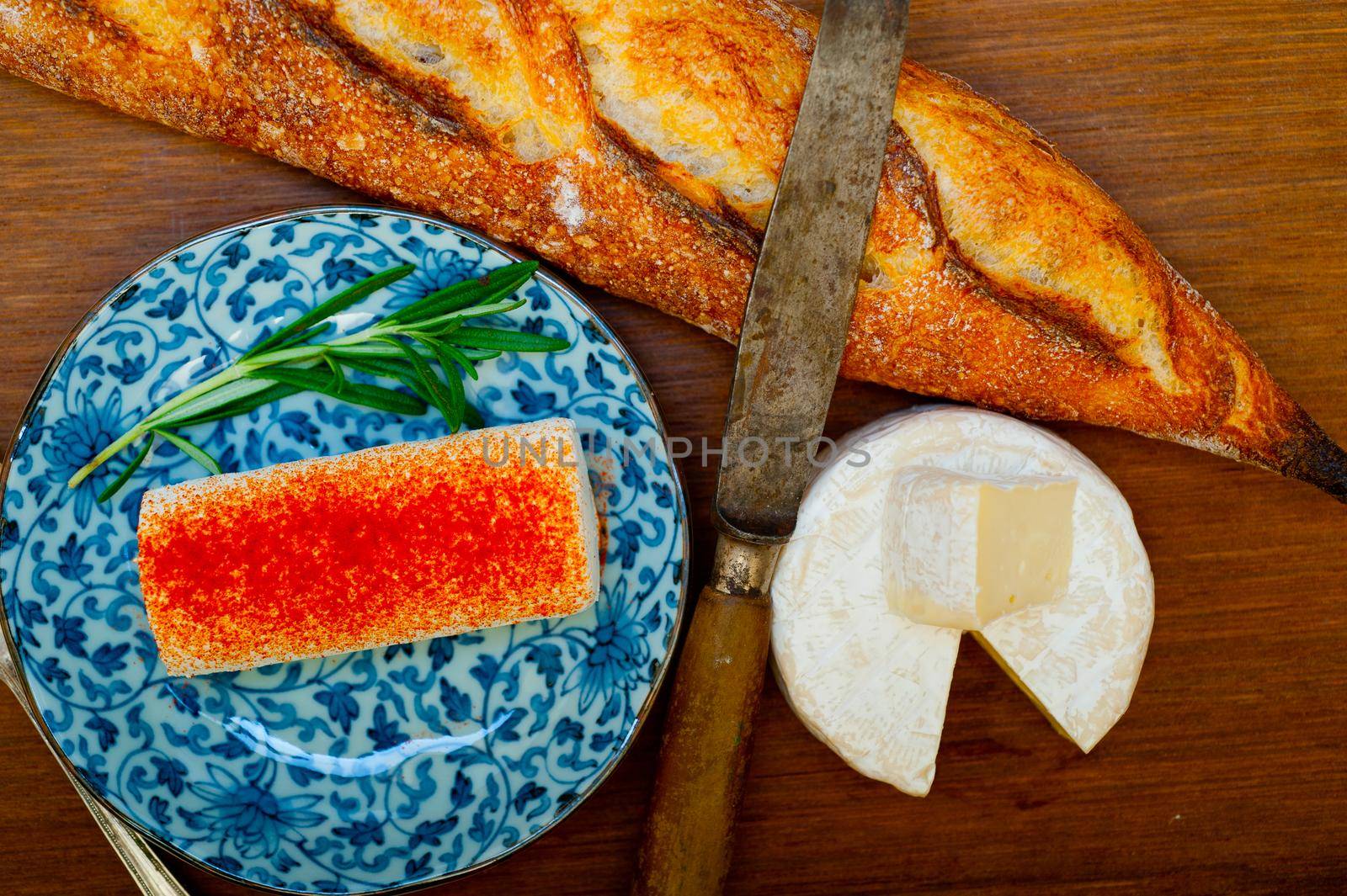 French cheese and fresh  baguette on a wood cutter by keko64