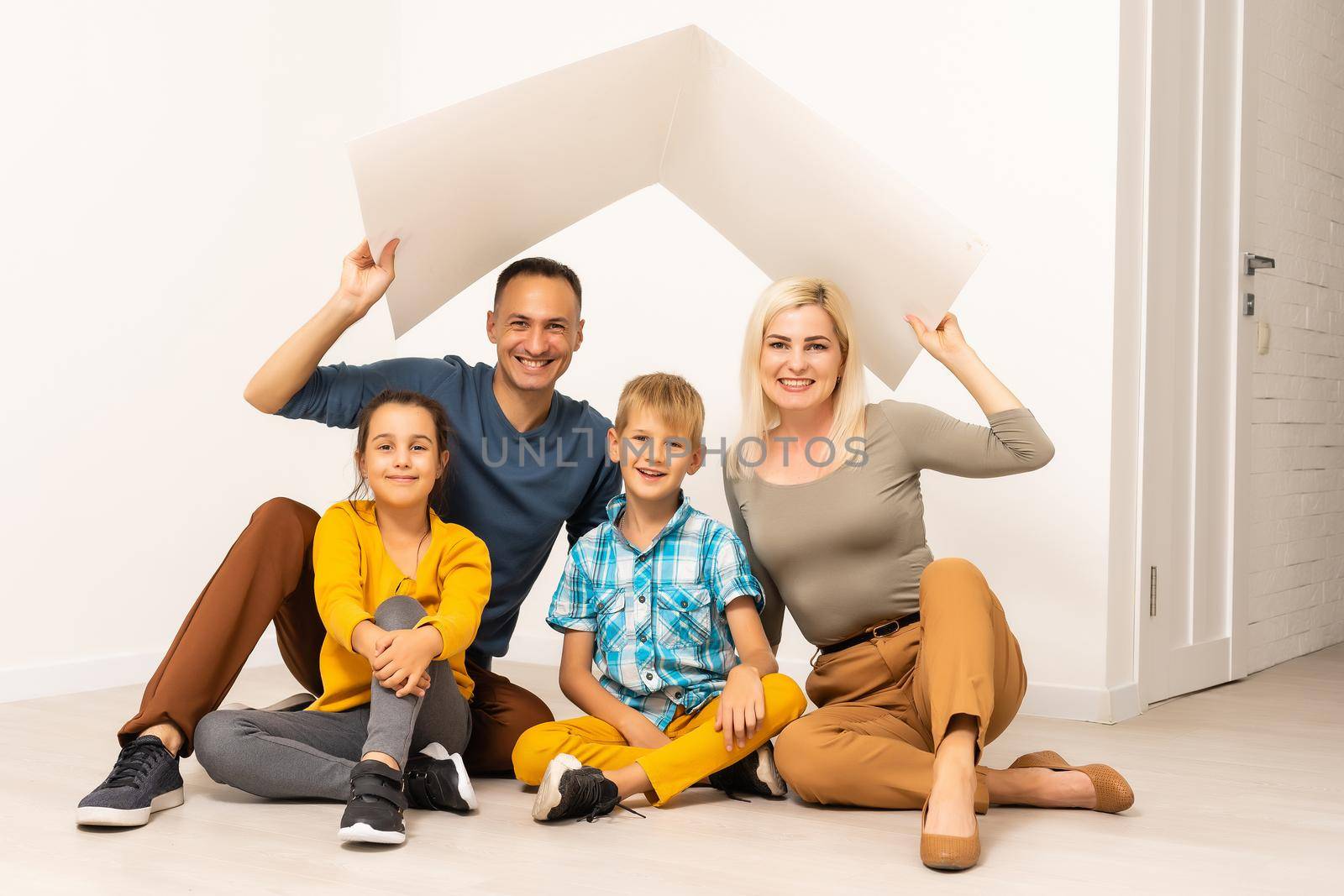 Happy family in a safe home - isolated over white background.