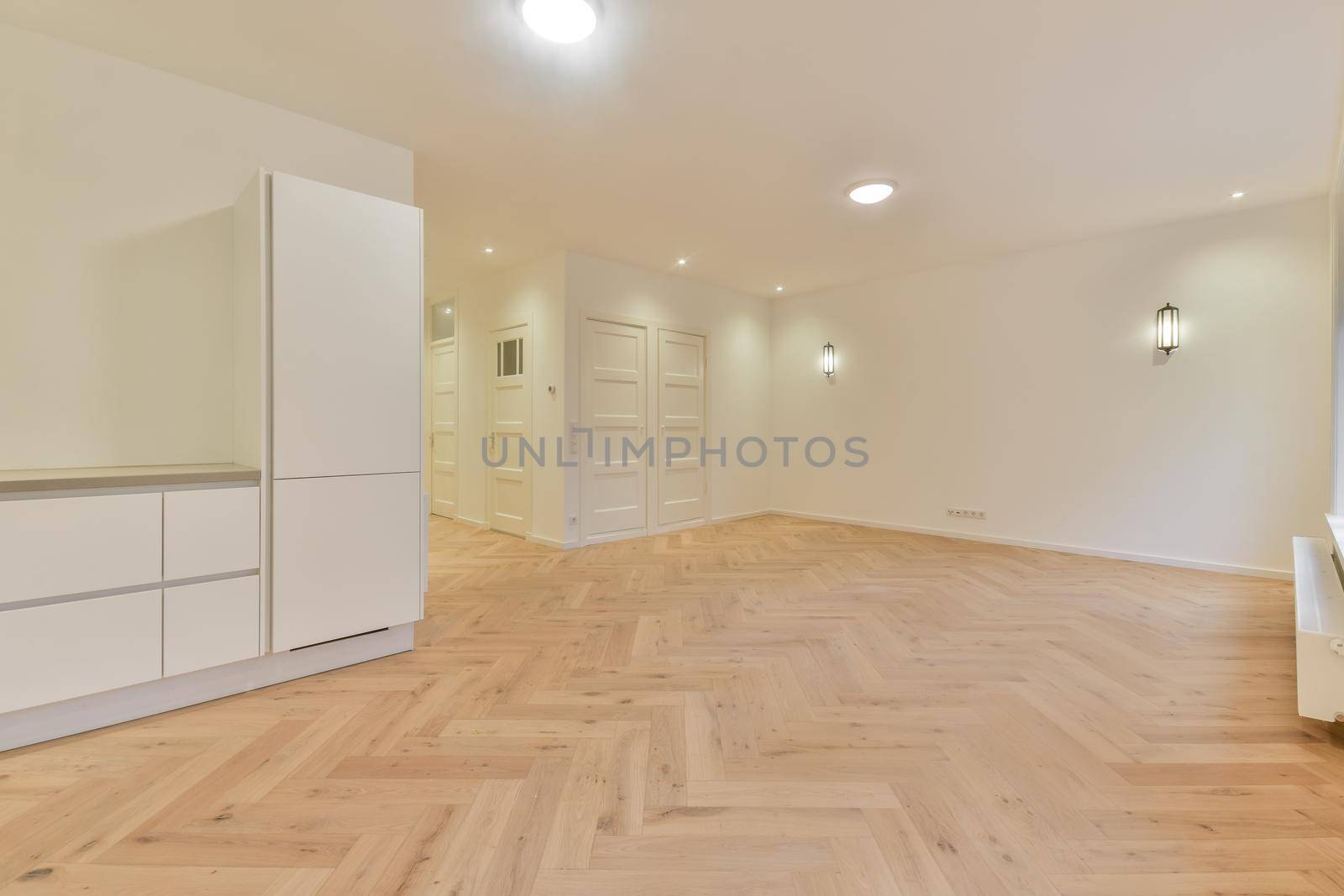 Modern room with wooden floor and white walls