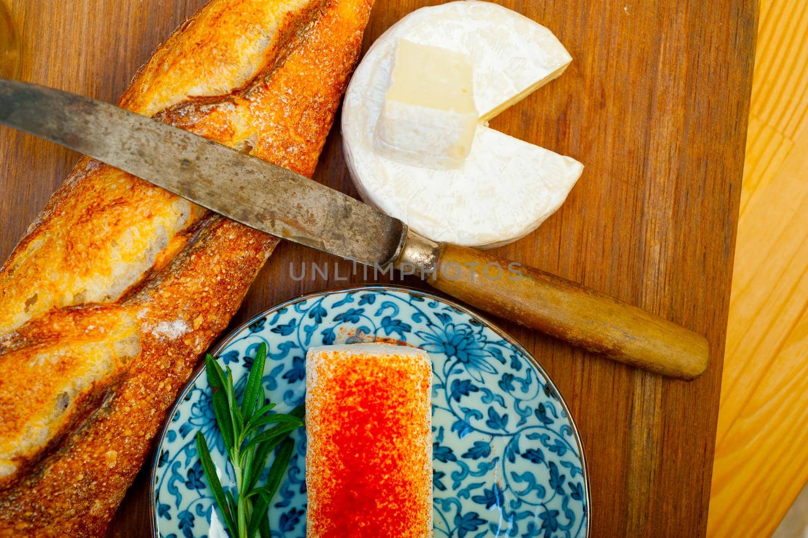 French cheese and fresh  baguette on a wood cutter by keko64