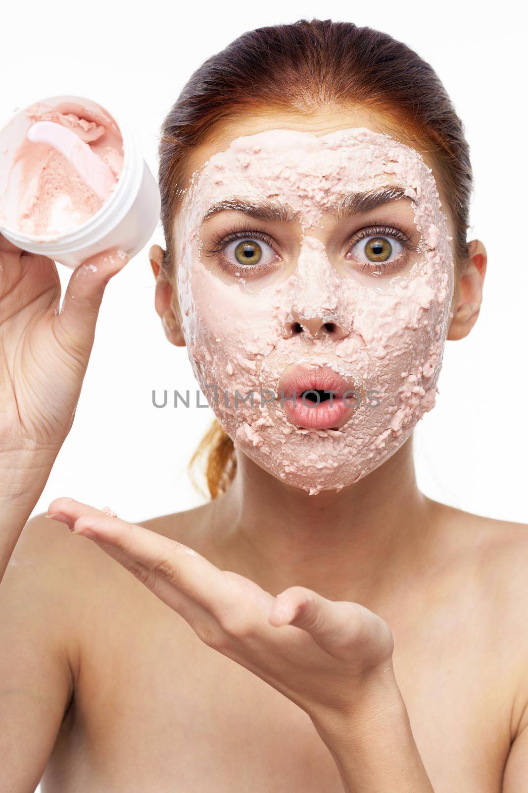 emotional woman cream face mask bare shoulders health. High quality photo