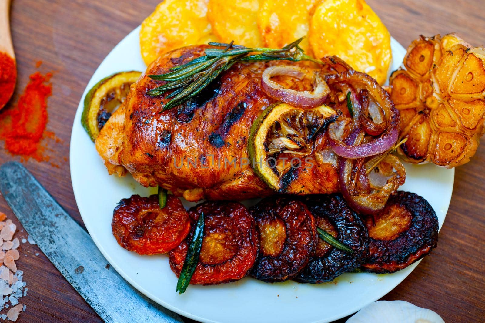 roasted grilled BBQ chicken breast with herbs and spices rustic style