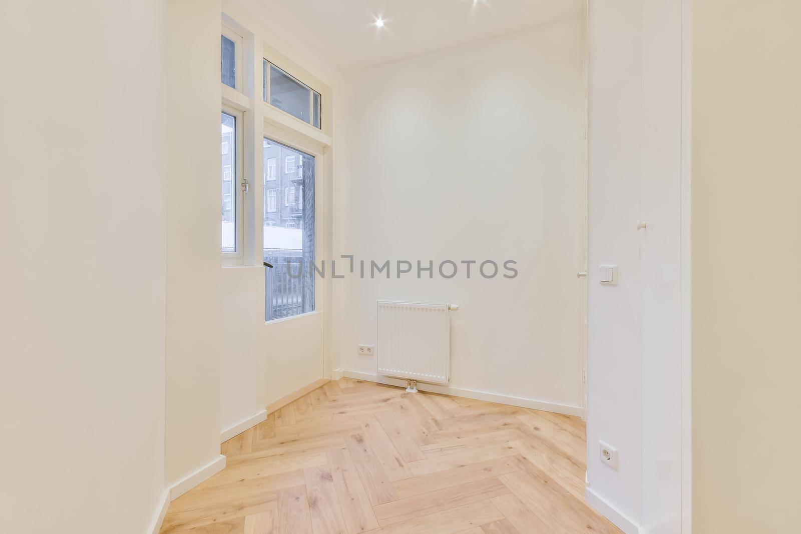 Modern room with wooden floor and white walls