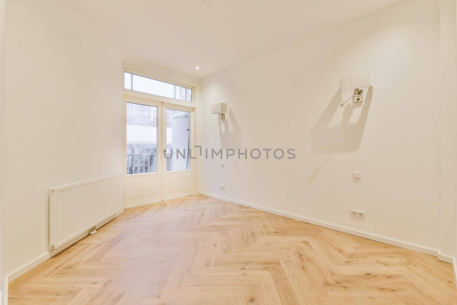 Modern room with wooden floor and white walls