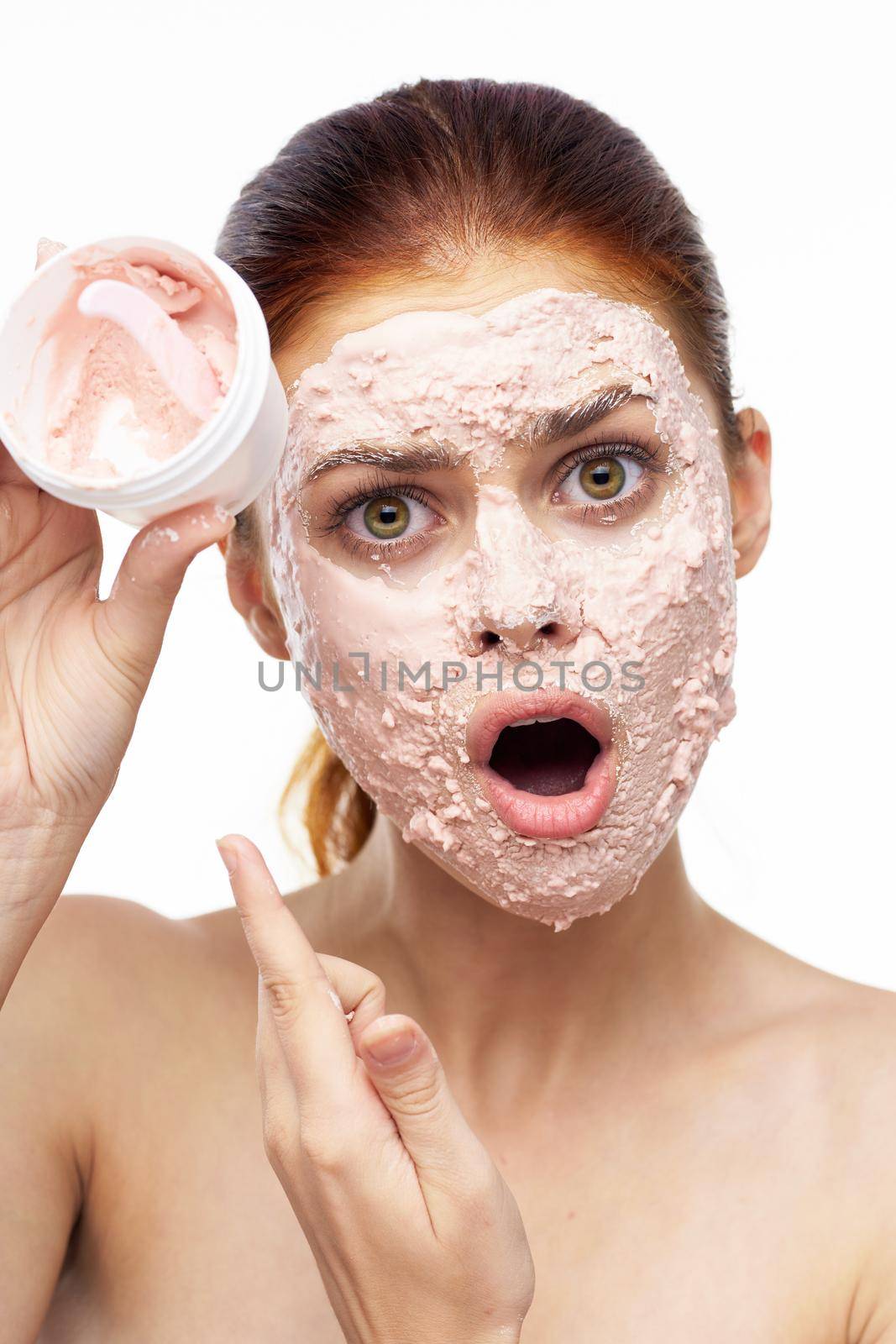 emotional woman cream face mask bare shoulders health. High quality photo