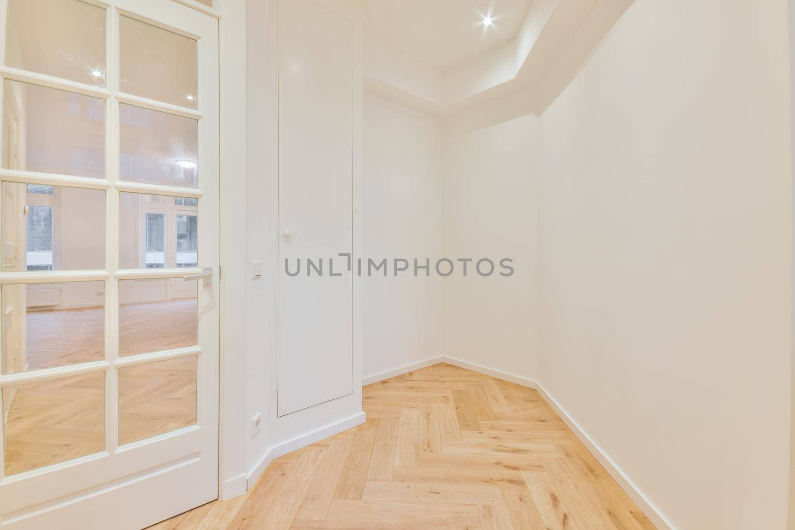 Modern room with wooden floor and white walls
