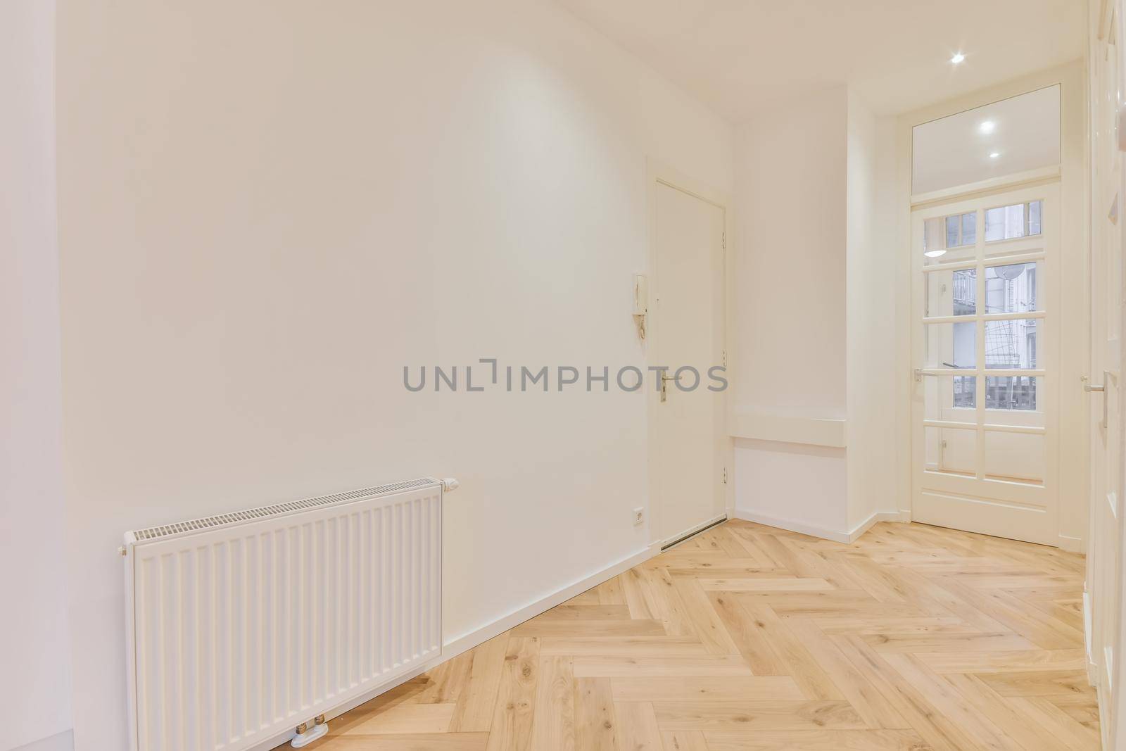 Modern room with wooden floor and white walls