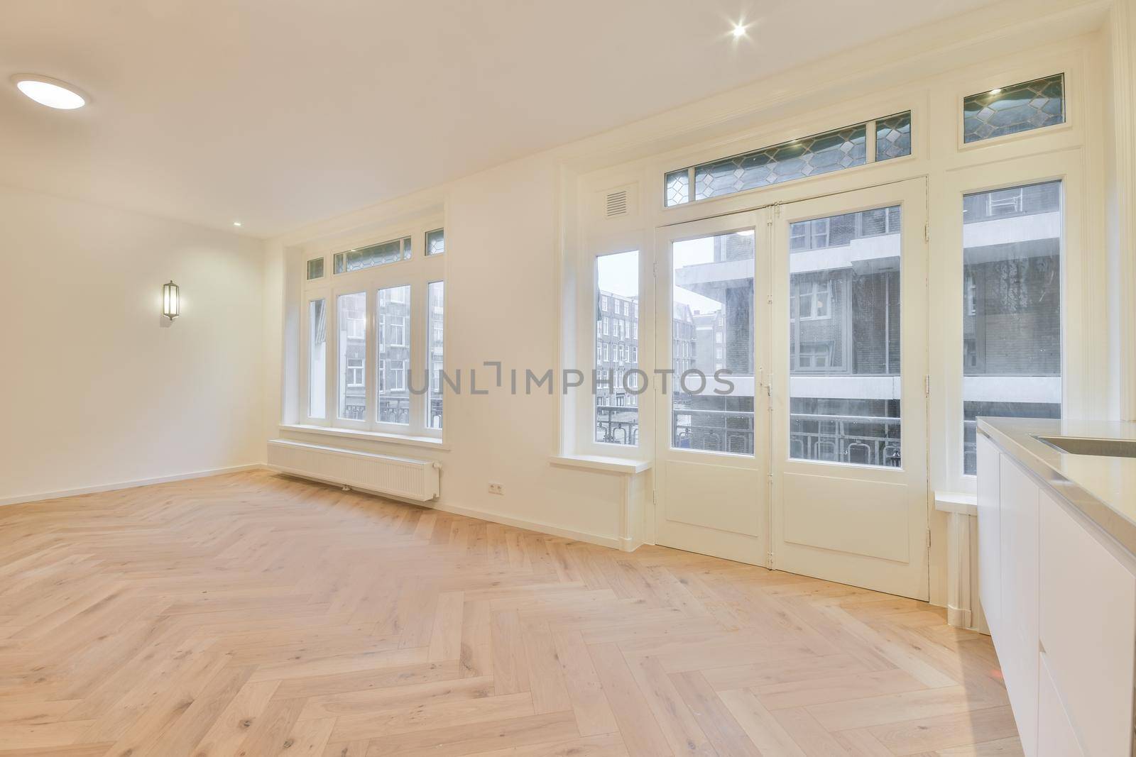 Modern room with wooden floor and white walls