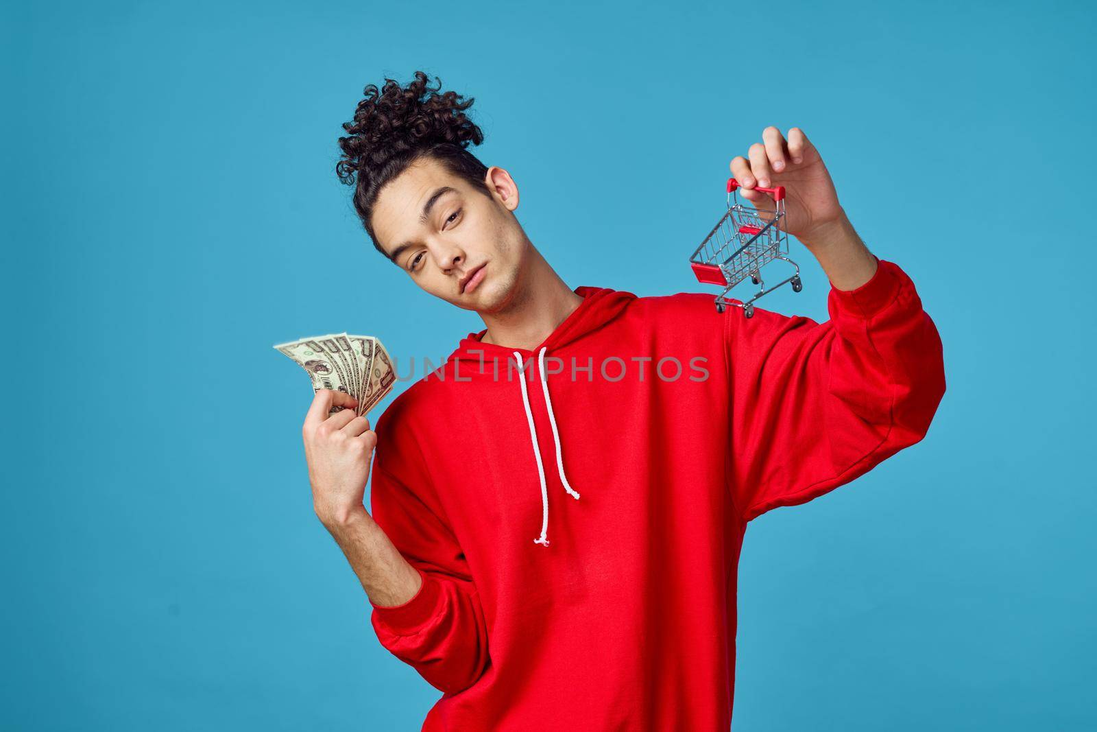 curly guy in a red sweater posing fashion modern hipster style. High quality photo