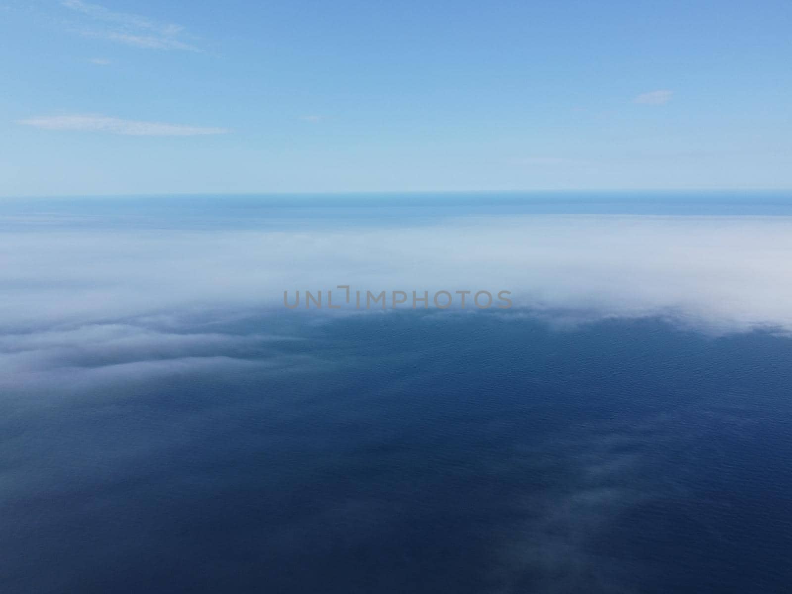 Abstract nature summer or spring ocean sea background. Small waves on water surface in motion blur with bokeh lights from sunrise.