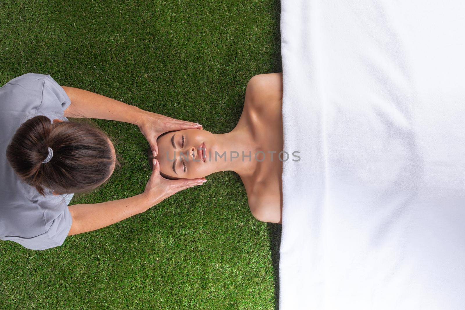 Woman at spa face massage by ALotOfPeople