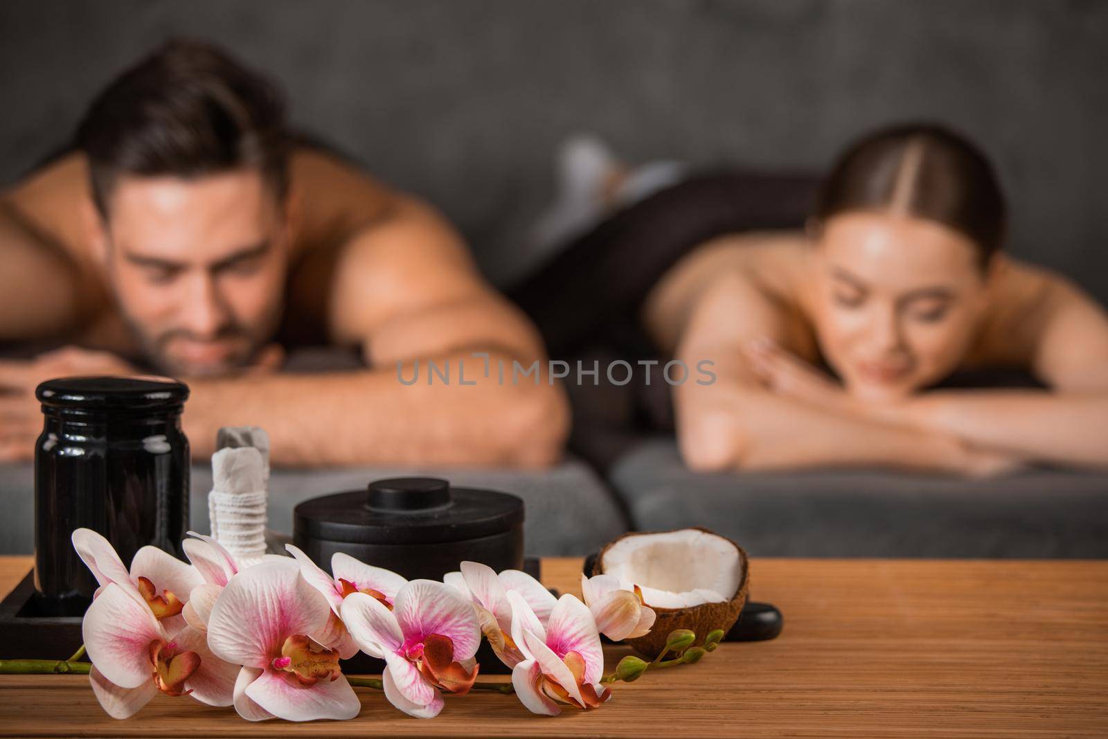 Couple lying on the massage desks on the spa salon. Beauty treatment concept.