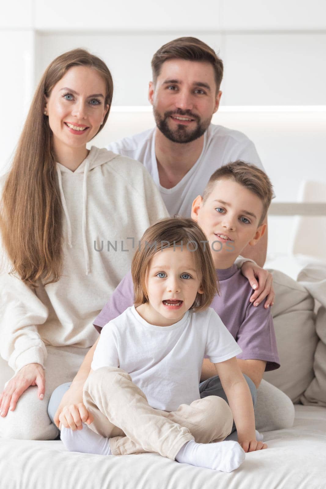 Portrait of a happy family smiling at home by ALotOfPeople