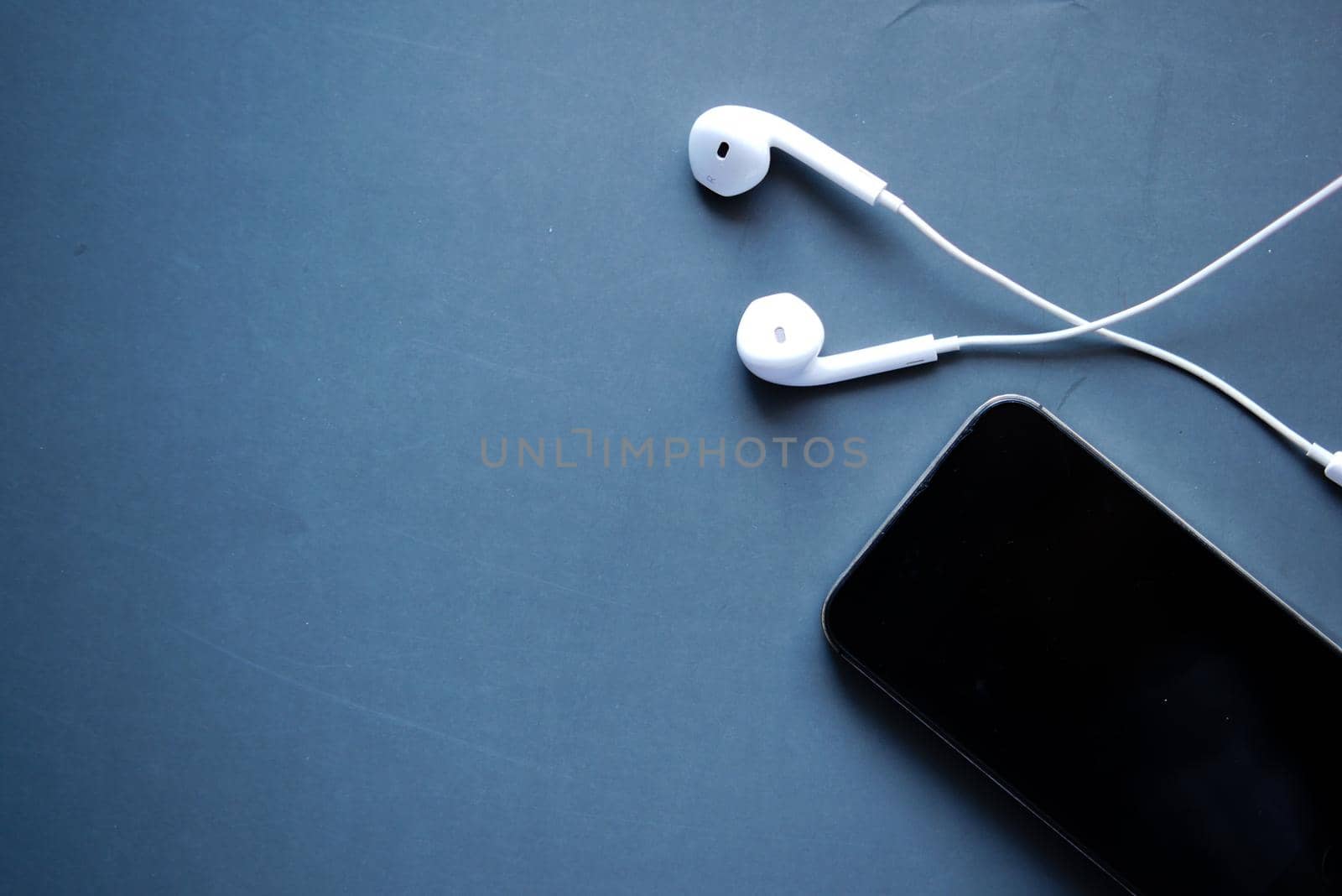smart phone and headphone on black background ..
