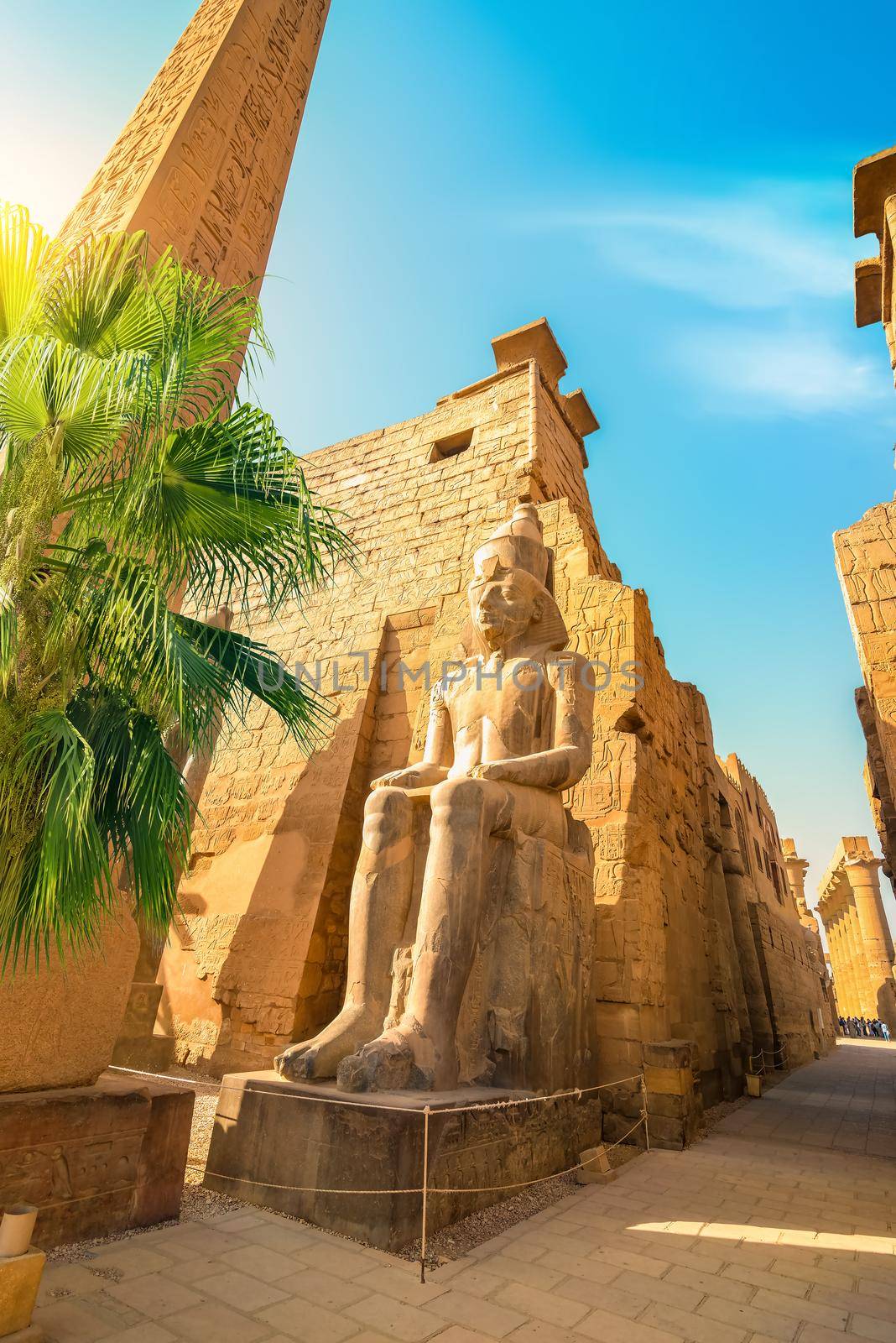 Luxor Karnak temple. The pylon with blue sky and palm