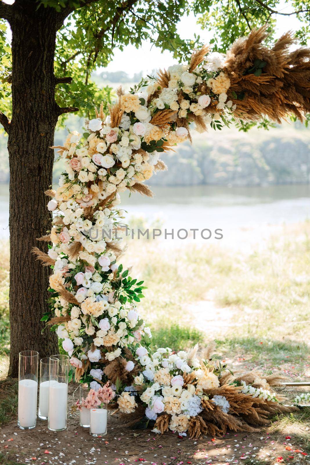 wedding ceremony area with dried flowers in a meadow in a green forest