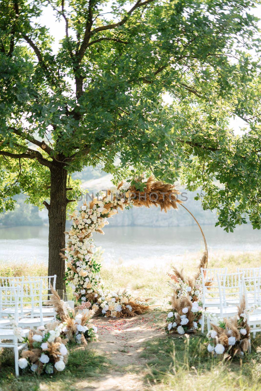 wedding ceremony area with dried flowers in a meadow in a green forest