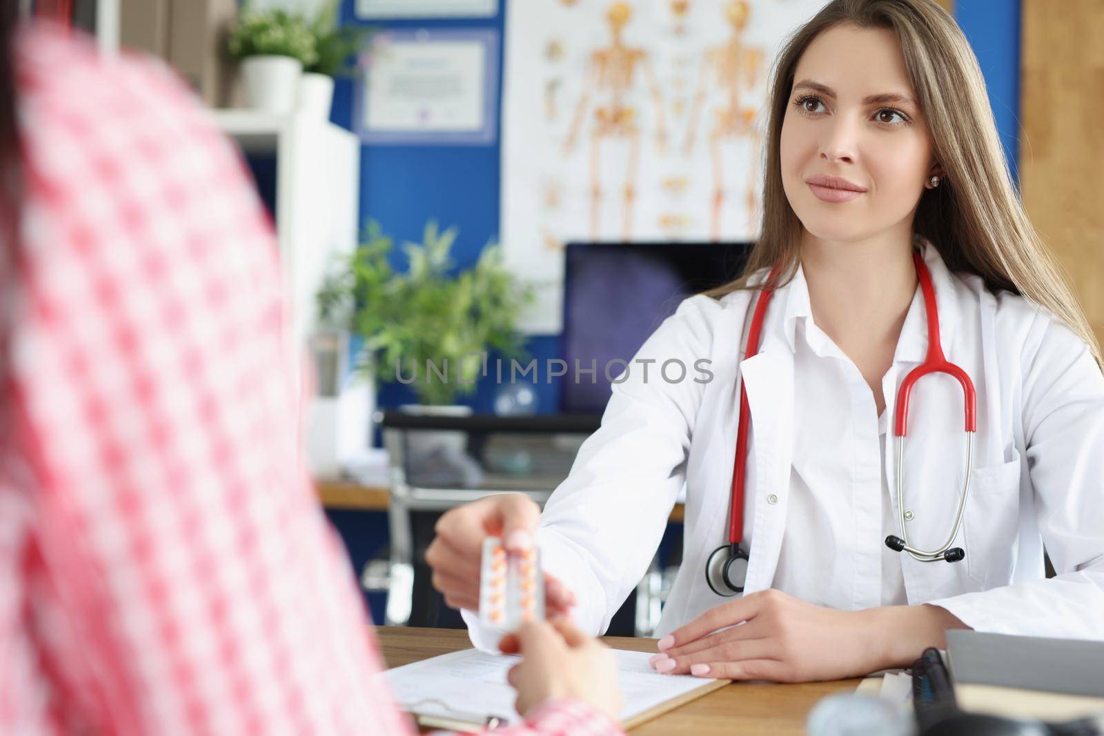 Portrait of qualified female doctor give tablets to patient for faster recovery. Woman on appointment get advice from professional. Medicine, help concept