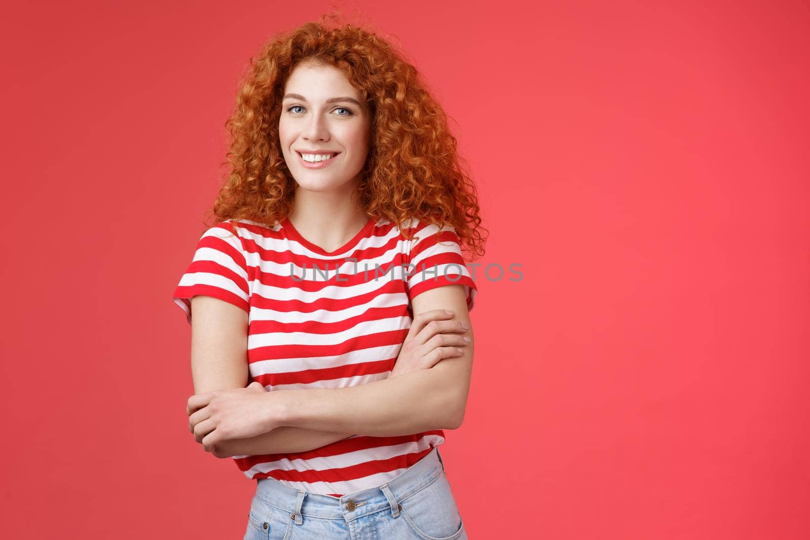 Confident tender silly redhead beautiful curly-haired girl cross arms body smiling broadly delighted amused cheerfully enjoy warm summer evening walks tropical country holiday red background.