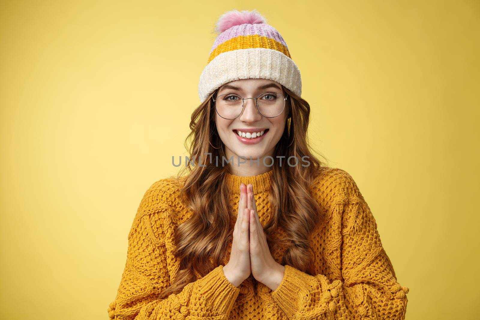 Thanks lot. Portrait charming tender cute european young woman thankfully looking camera bowing polite show namaste appreciation gesture press palms together smiling yellow background.