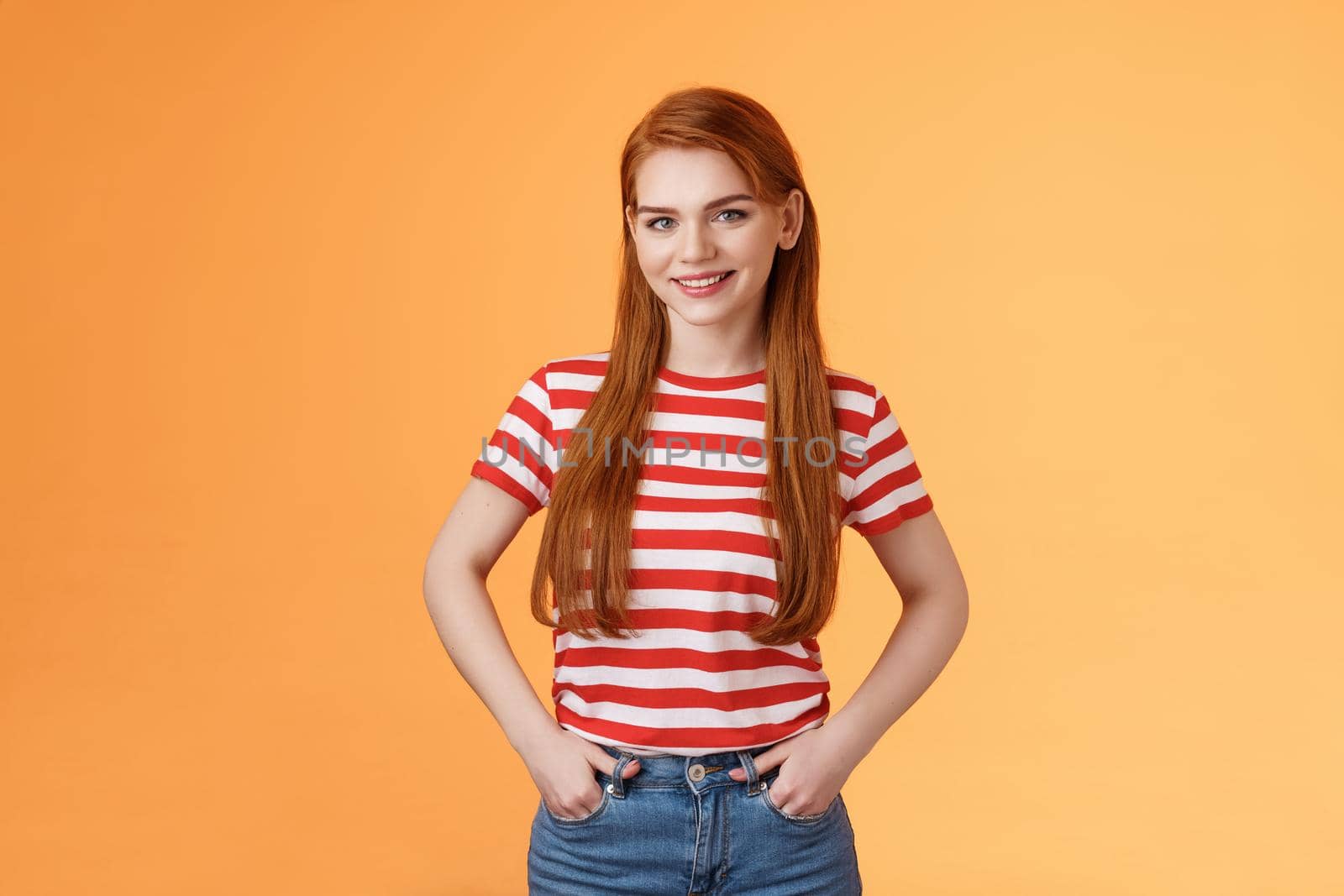 Skillful motivated cheerful redhead woman hold hands pants smiling empowered, professional entrepreneur grinning satisfied managing business alone, good start-up, orange background.