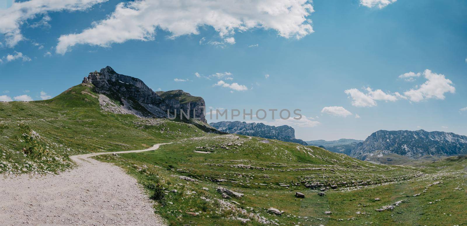 Amaizing sunset view on Durmitor mountains, National Park, Mediterranean, Montenegro, Balkans, Europe. Bright summer view from Sedlo pass. Instagram picture. The road near the house in the mountains