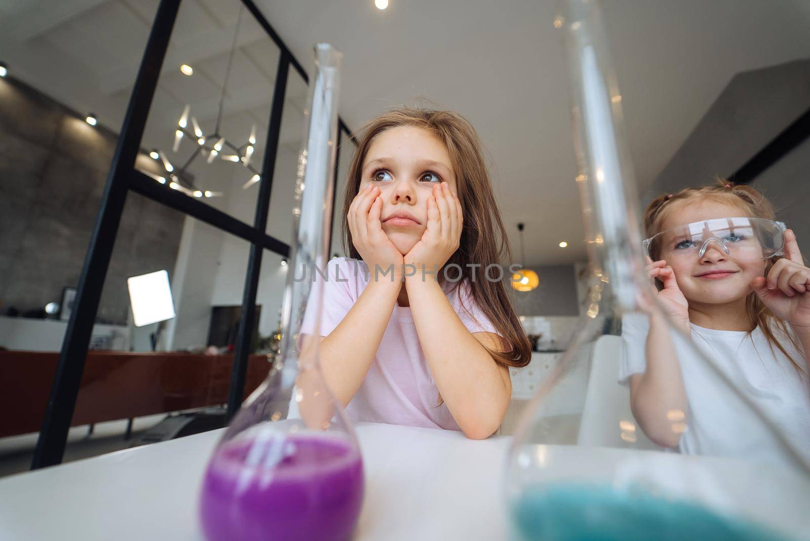 Girls making chemical experiments at home, close view.