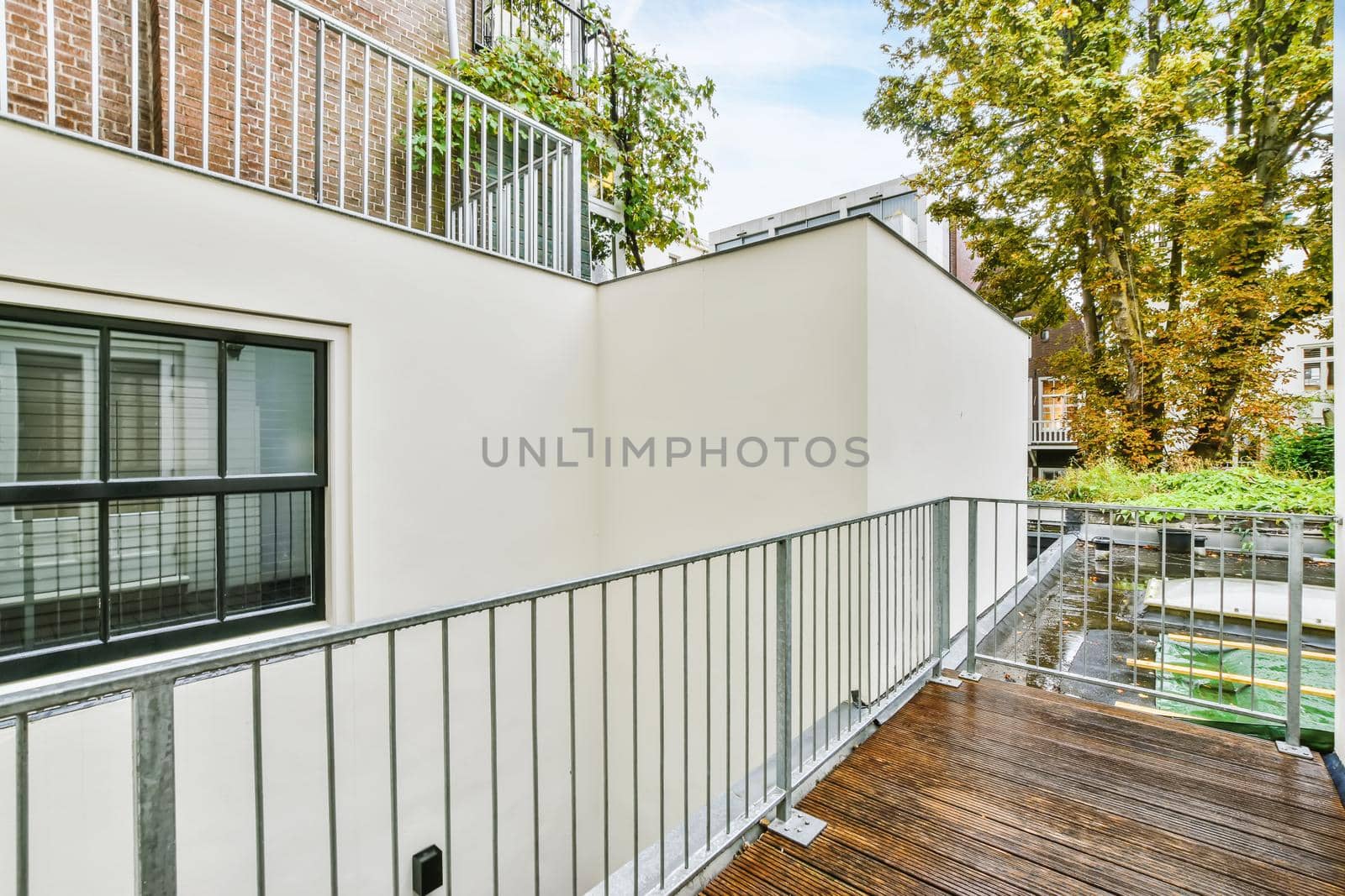 Cozy pretty balcony with comfortable railings and wooden floor