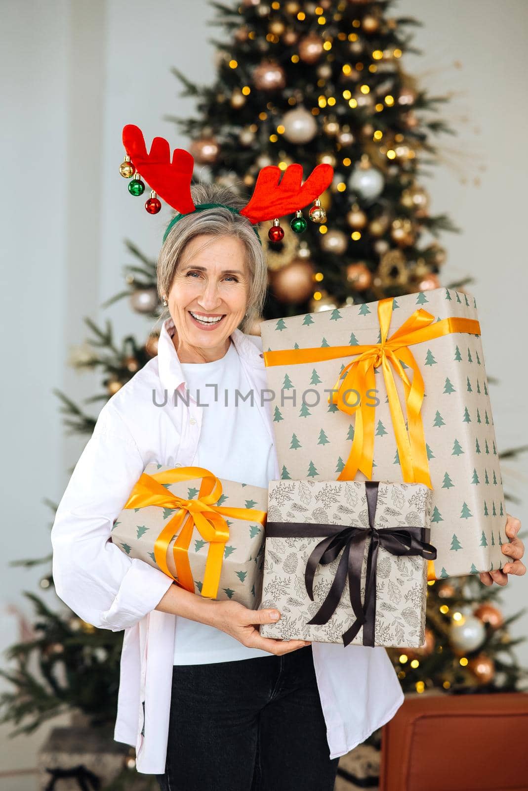 Grandma wearing deer christmas hat, happy smiling face.