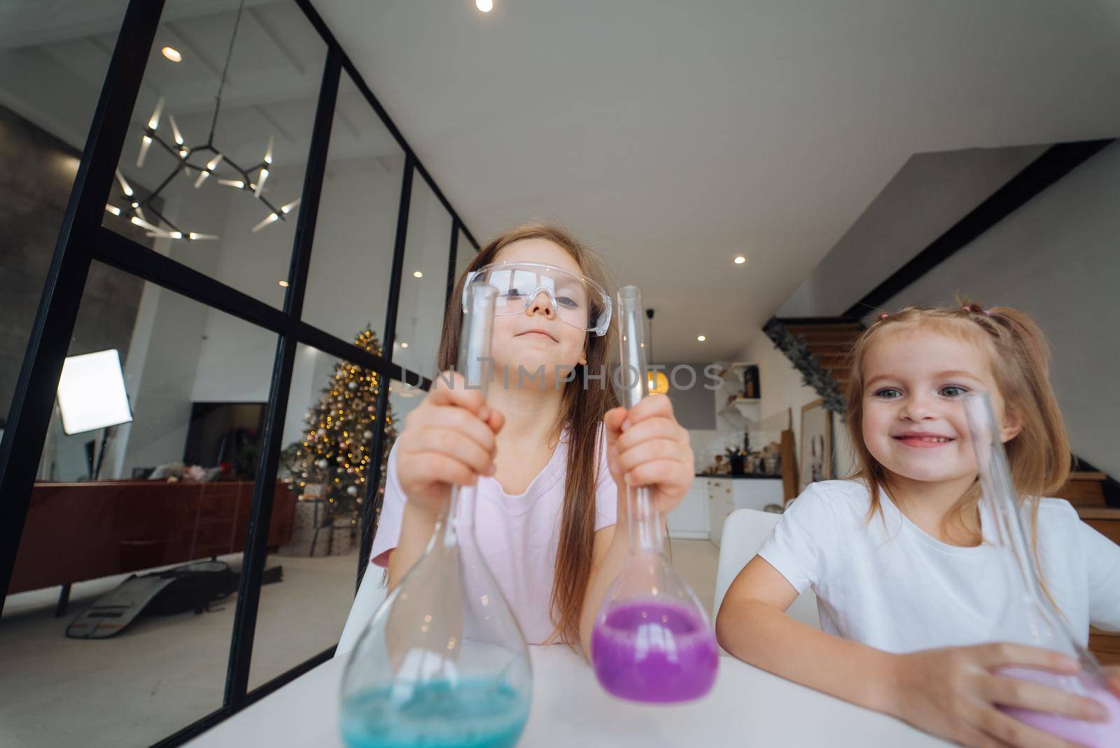 Girls making chemical experiments at home, close view.