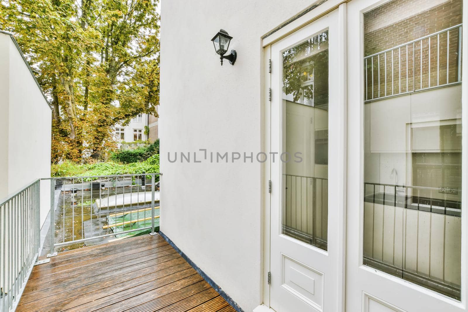 Cozy pretty balcony with comfortable railings and wooden floor
