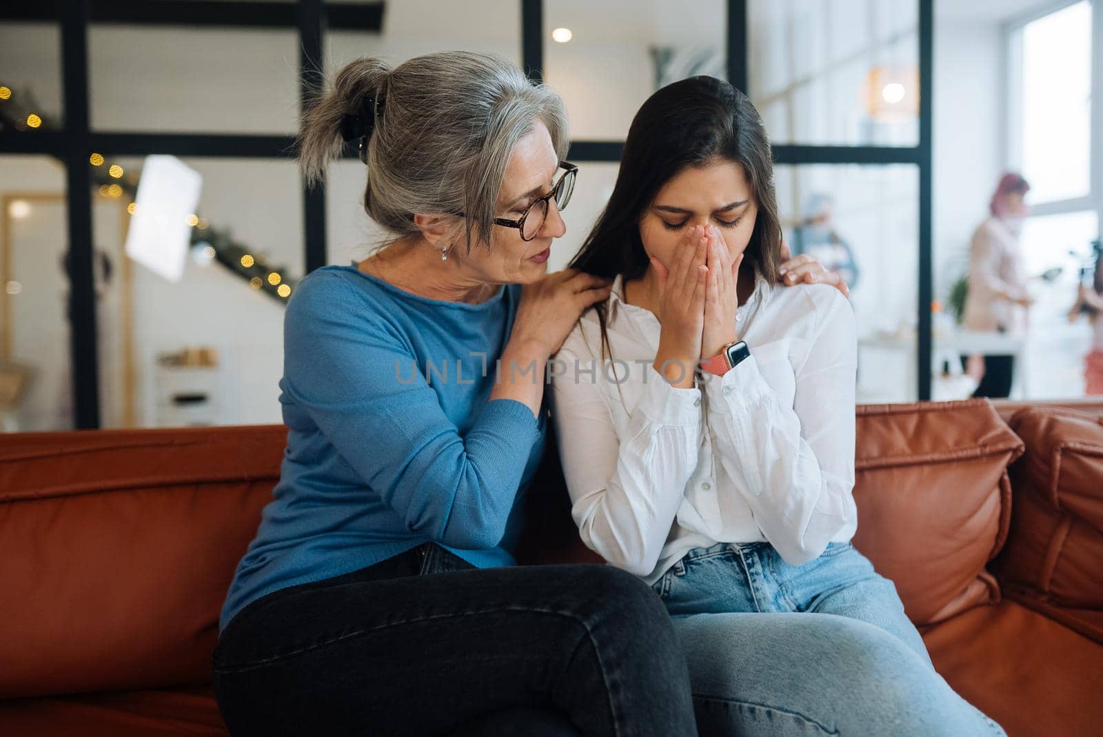 Grandmother comforting her sad granddaughter at home. Support concept