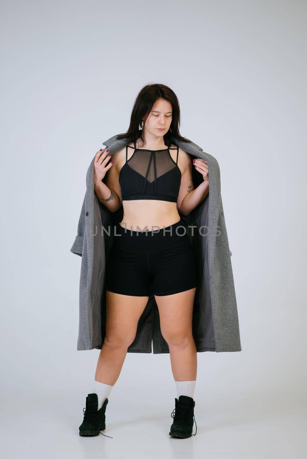 Plus size body positive woman wearing comfortable underwear and coat