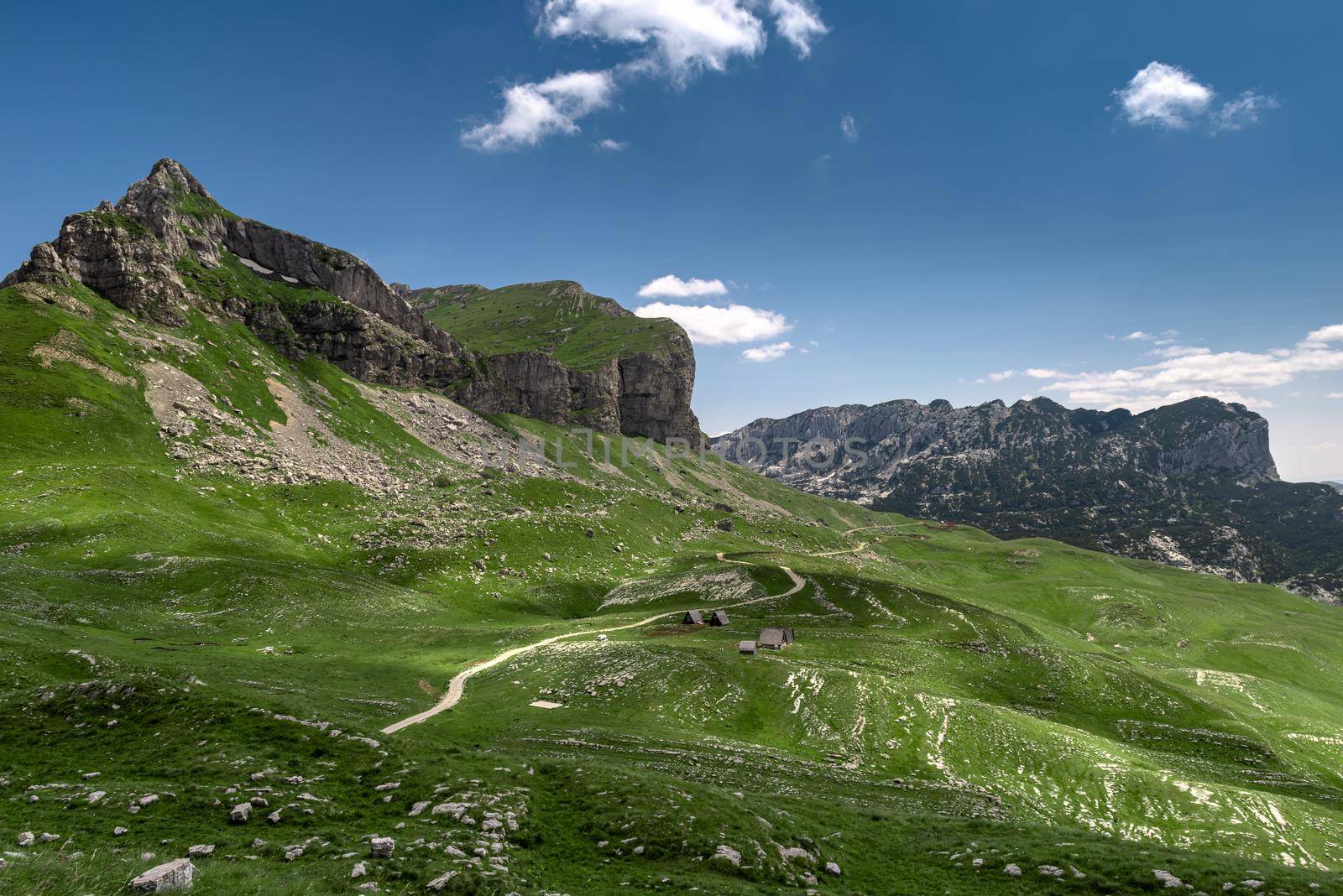 Amaizing sunset view on Durmitor mountains, National Park, Mediterranean, Montenegro, Balkans, Europe. Bright summer view from Sedlo pass. Instagram picture. The road near the house in the mountains