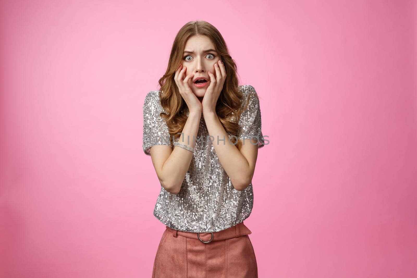 Shocked concerned attractive female student gasping gosh what happened widen eyes shocked drop jaw panicking freak-out touching face worried, standing anxious pink background. Copy space