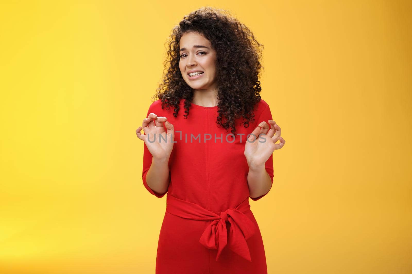 Girl hates washing dished grimacing from dislike and disgust wanting puke from aversion raising palms and stepping back frowning refusing displeasing offer over yellow background by Benzoix
