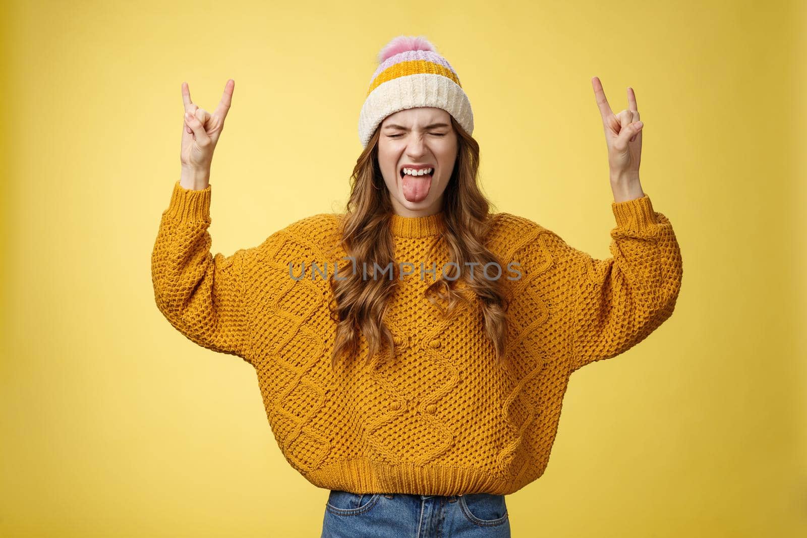 Awesome party rocks. Portrait amused carefree good-looking stylish girl having fun dancing dance floor heavy metal concert show rock-n-roll gesture show tongue rebellious close eyes enjoying music.