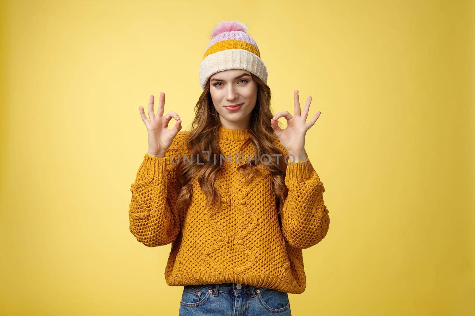 You look awesome. Portrait satisfied good-looking girl show okay gesture delighted good result, excellent perfect work, assuring no problem, smiling devious check out cool shot, yellow background.