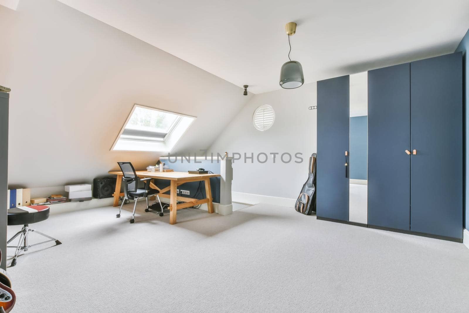 Attic studio room in white and blue colors