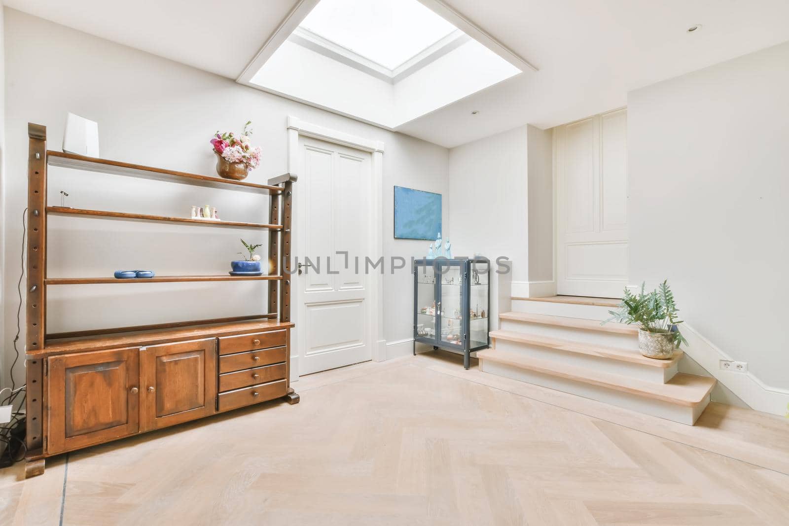 Bright room with a wooden wardrobe and a window on the ceiling