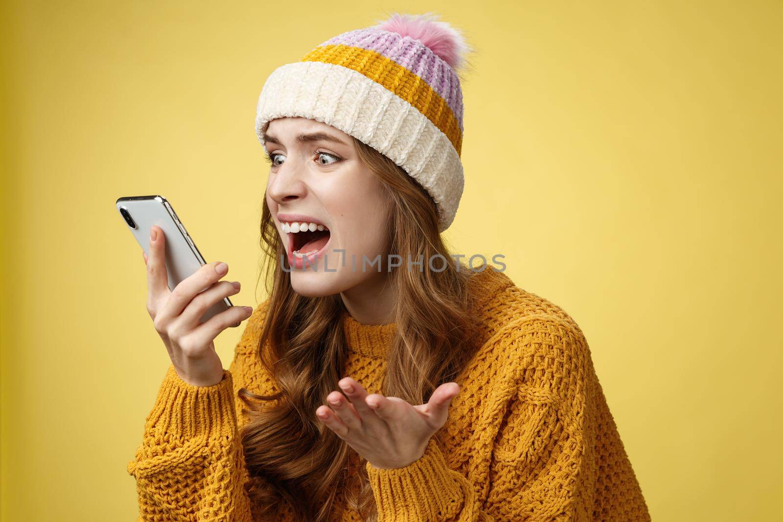 Annoyed pissed freak-out crazy woman shouting smartphone look display near face irritated arguing boyfriend breaking-up via phone call standing angry furiously yelling cellphone, raise hand dismay by Benzoix