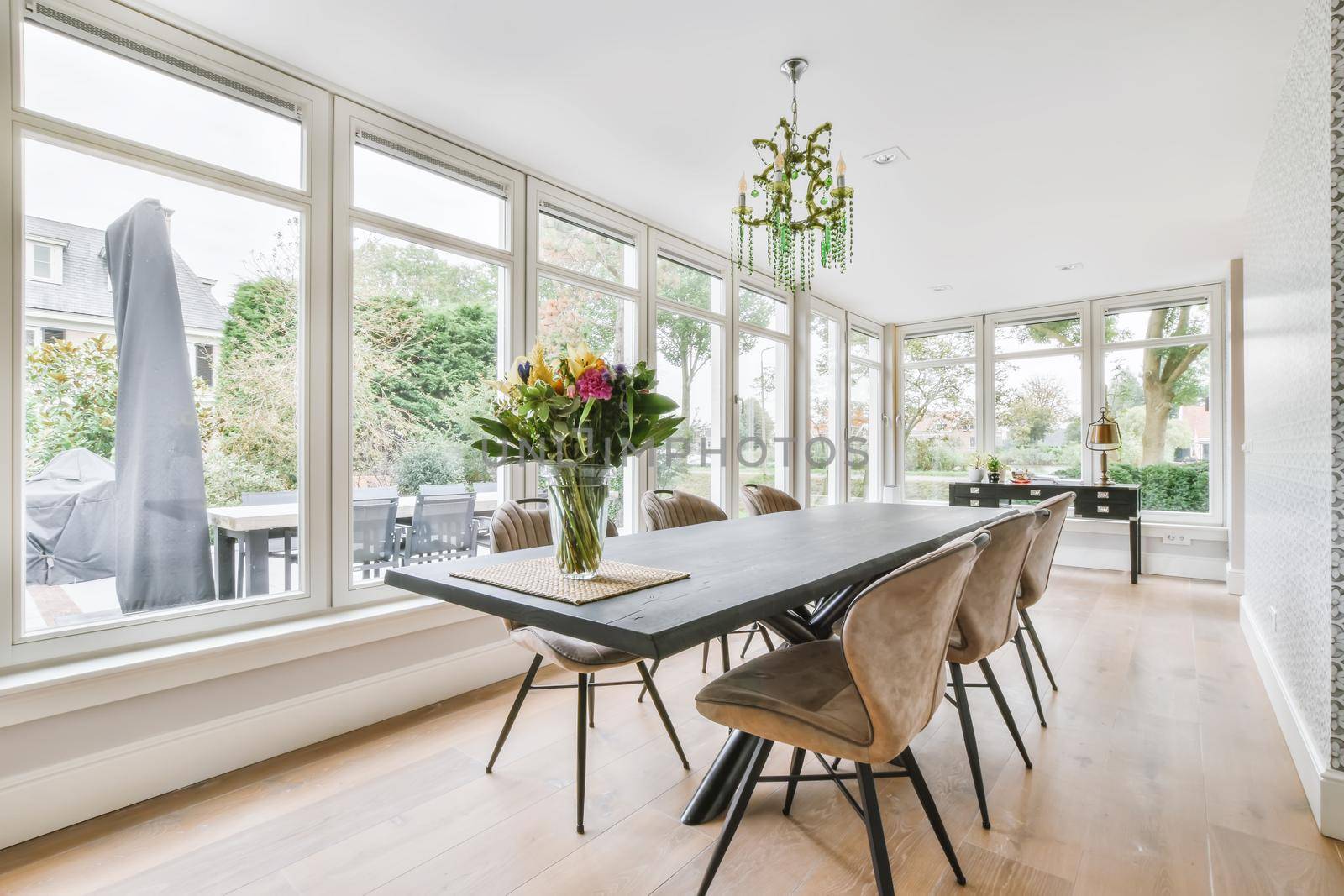 Large dining room with large table and chairs and a full side wall window