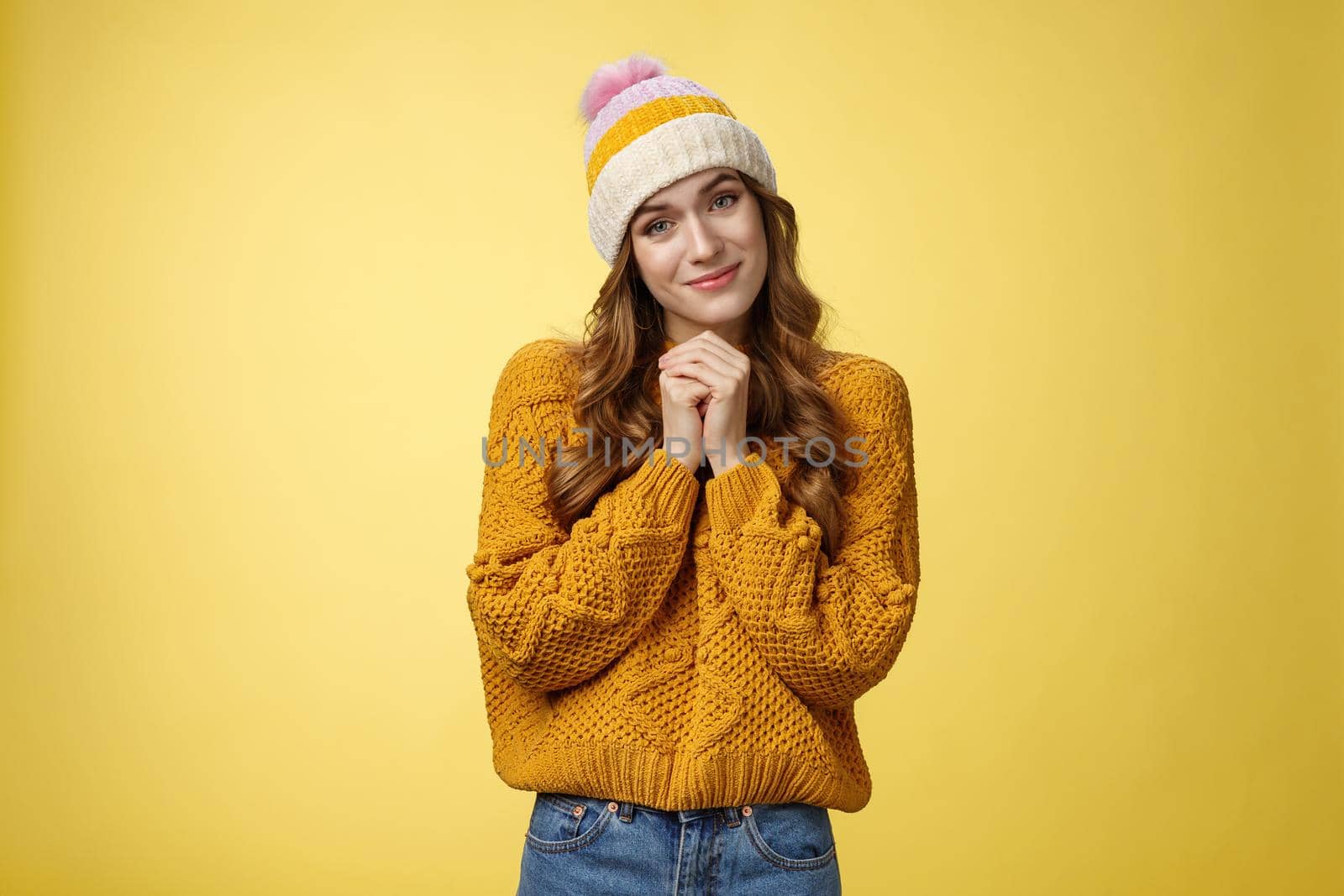 Touched charming cute silly young girl make flirty gazes camera press palms together checking out something moving cute, tilting head seeing adorable kitten, smiling delighted yellow background by Benzoix
