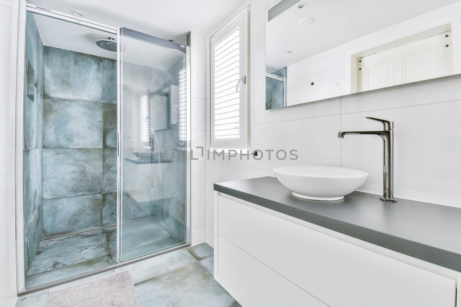 Stylish bathroom with large marble tiles on the walls and floor