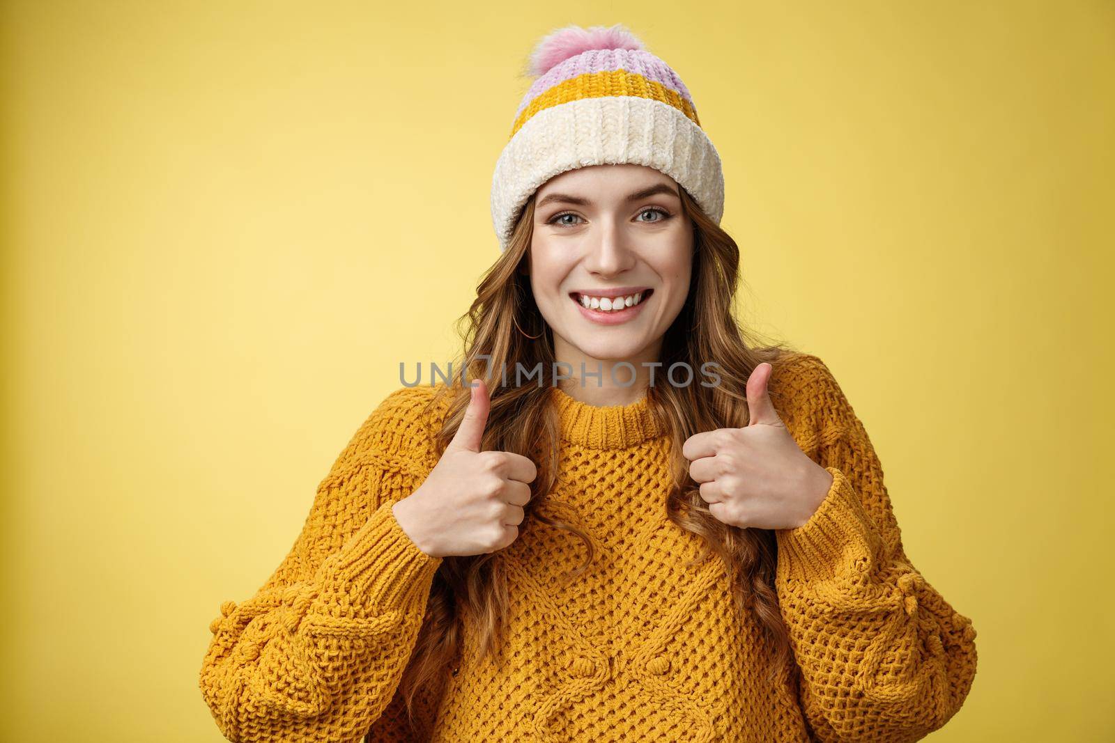 Close-up charming supportive kind young woman show thumbs-up gesture smiling approval liking your idea encourage keep up, satisfied good excellent choice, standing pleased yellow background.