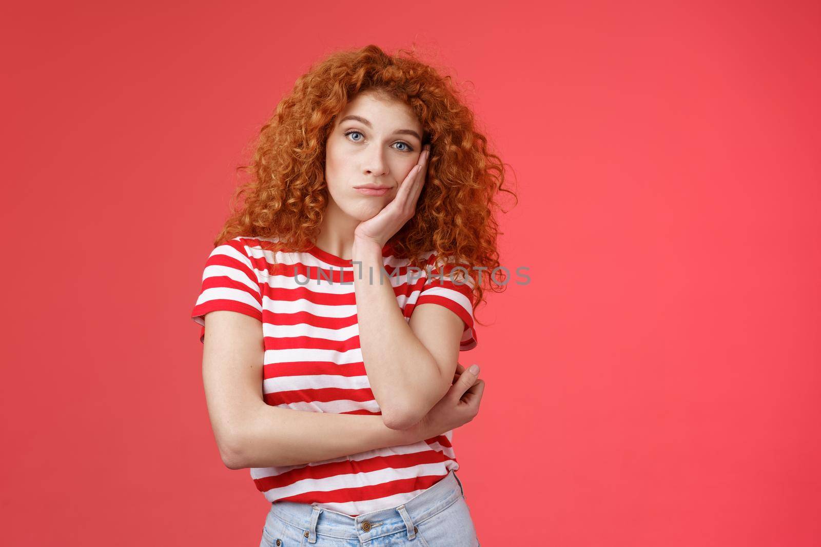 Playful redhead gorgeous girl feel sad lacking energizing party lean palm look indifferent express boredom lonely feelings attend boring meeting standing upset reluctant red background.