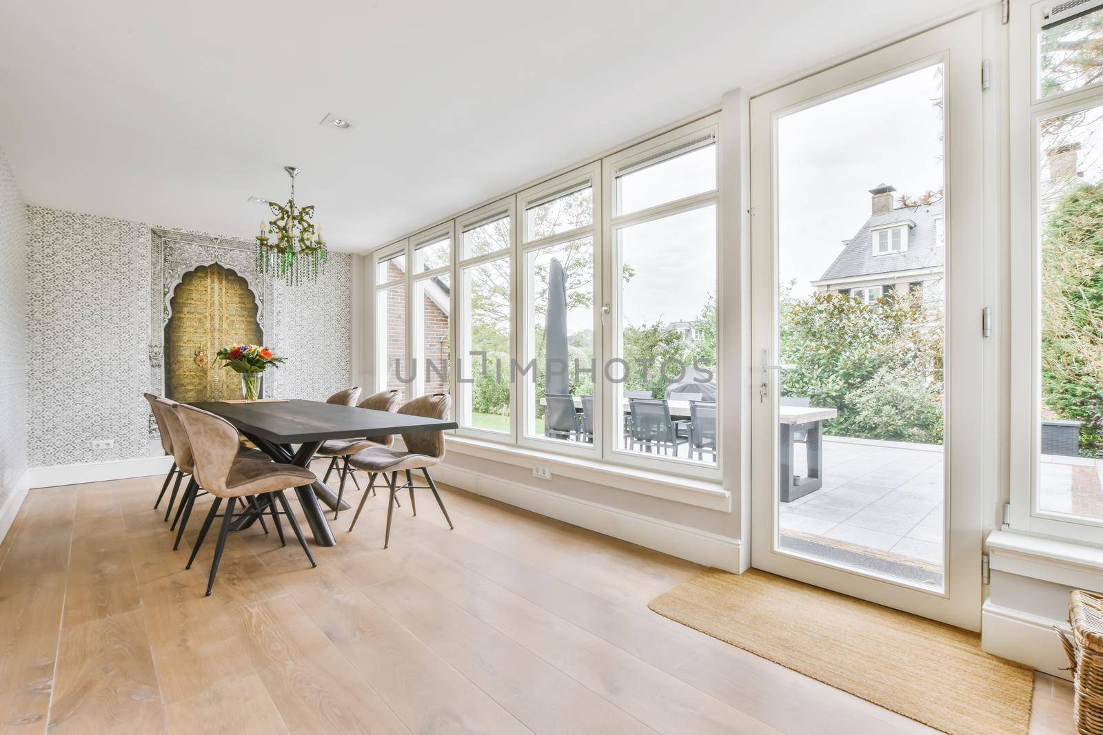 Large dining room with large table and chairs and a full side wall window