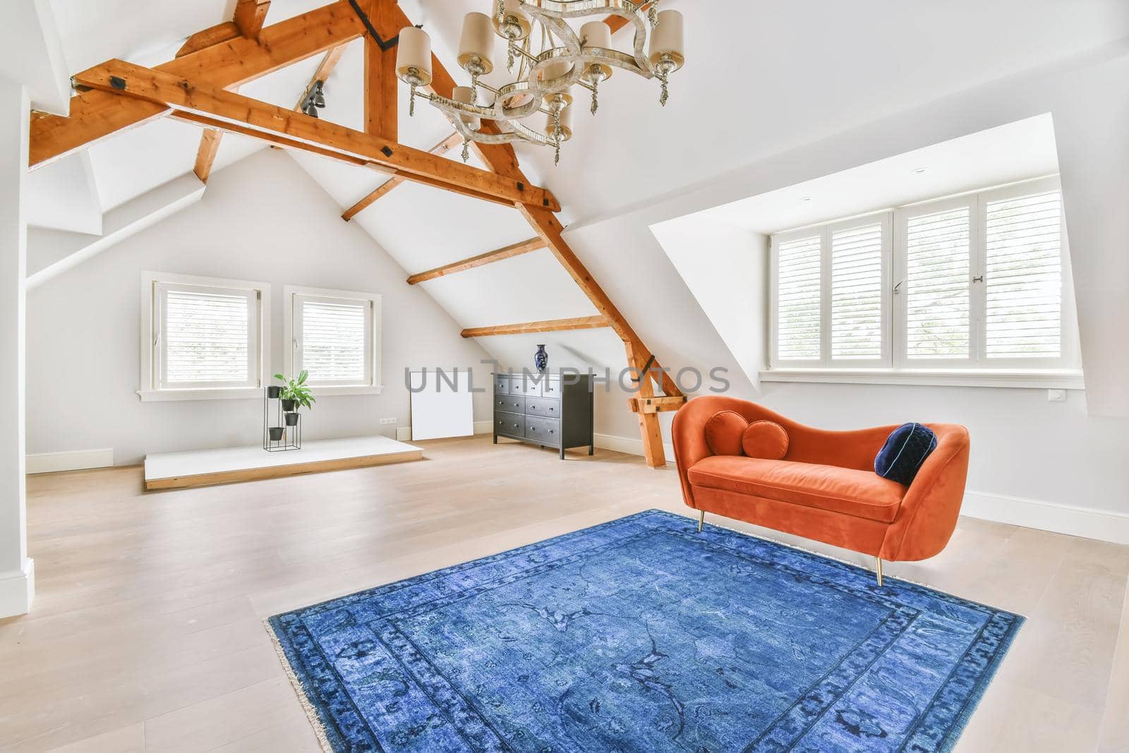 Cozy bright room with a bright red sofa in the middle