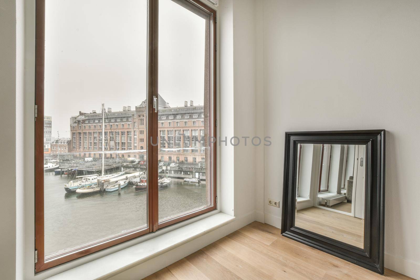 Modern room with wooden floor and white walls