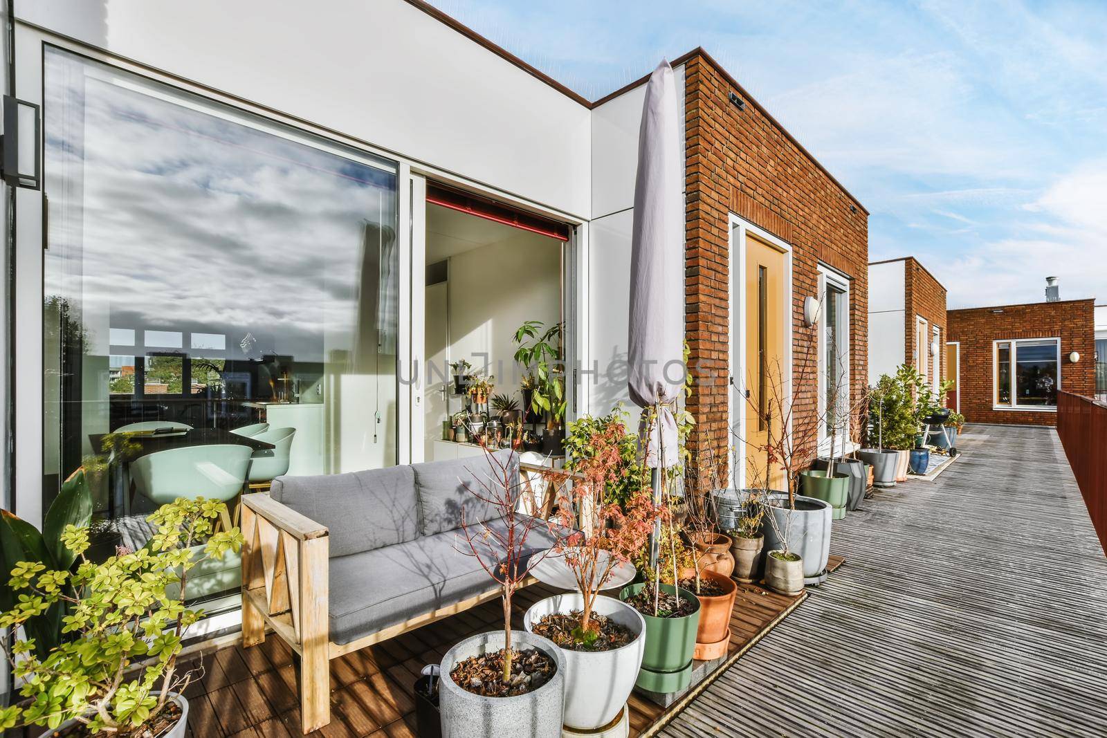 Attractive back of the apartment with open door and bench